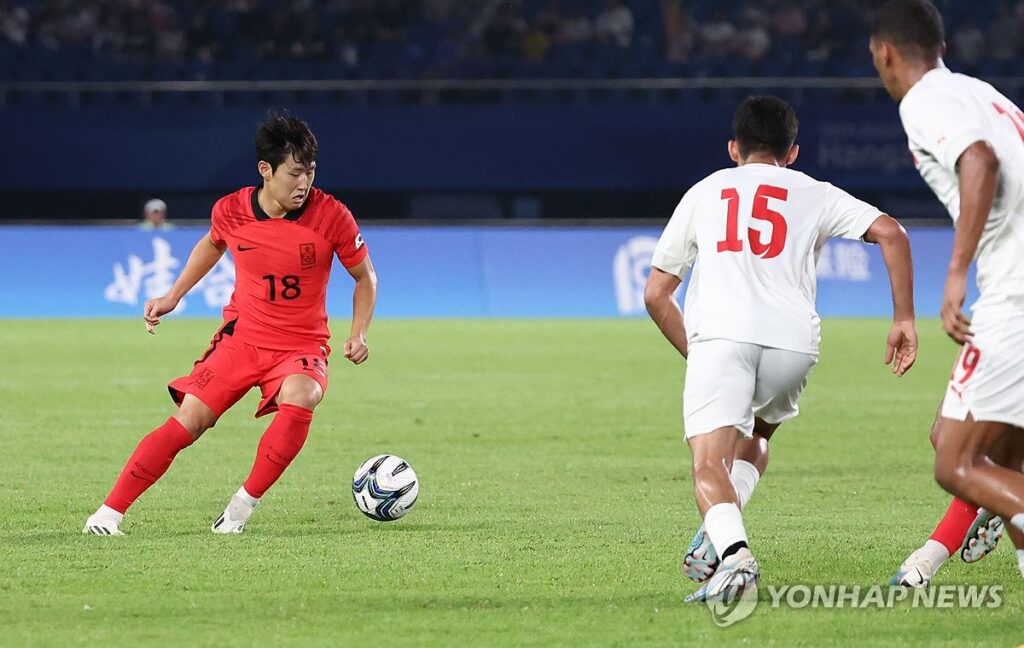 men kicking the soccerball in football league